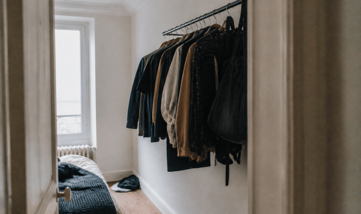 Penderie murale avec vetements suspendus dans chambre etroite